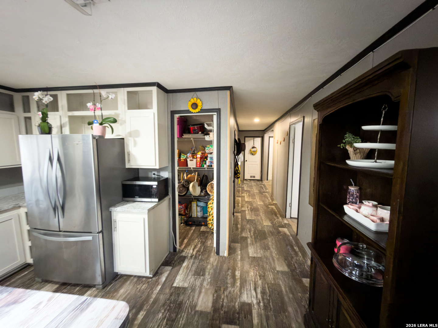 114 4th Street Natalia, TX 78059 - Photo 6 of 32 a kitchen with a refrigerator and a stove