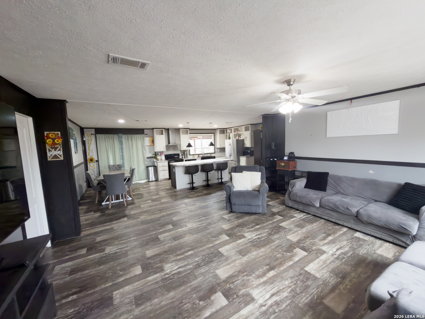 114 4th Street Natalia, TX 78059 - Photo 9 of 32 a living room with furniture and a flat screen tv