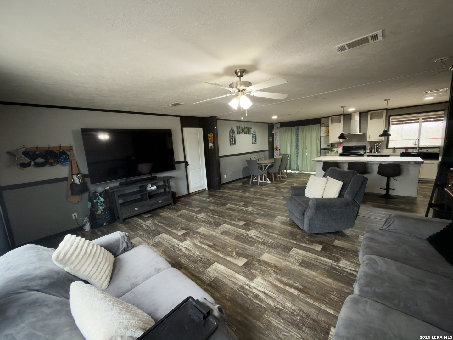 114 4th Street Natalia, TX 78059 - Photo 10 of 32 a living room with furniture and a flat screen tv