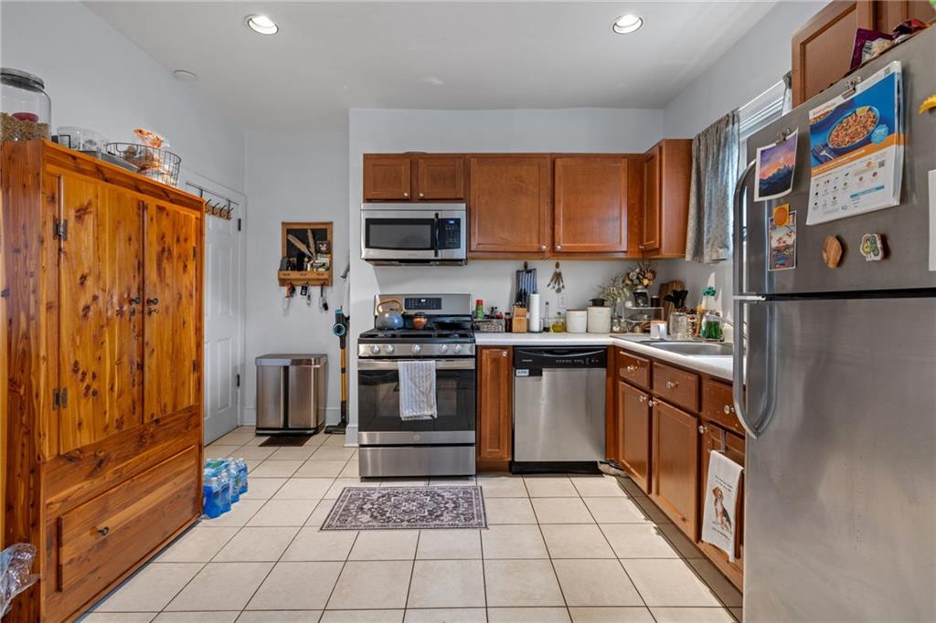 5211 Kent Way Pittsburgh, PA 15201 - Photo 7 of 18 a kitchen with stainless steel appliances a refrigerator sink and microwave