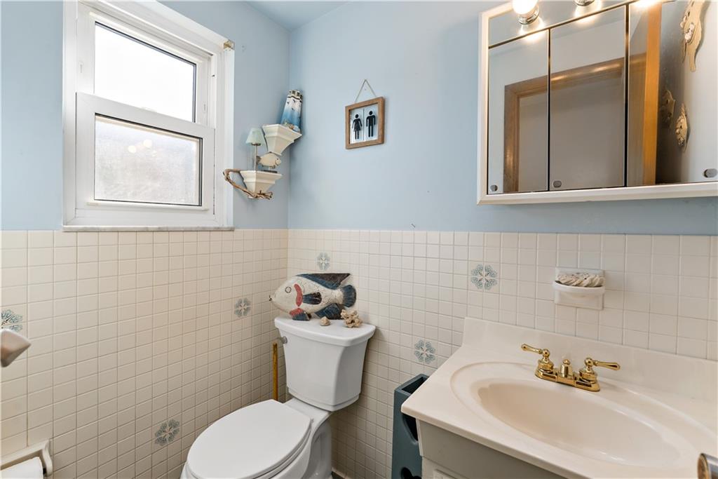38 May Avenue McKees Rocks, PA 15136 - Photo 15 of 38 a white toilet sitting next to a bathroom sink
