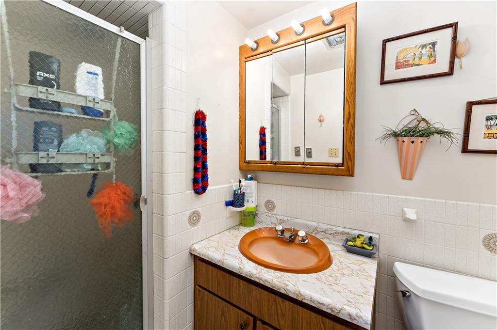 38 May Avenue McKees Rocks, PA 15136 - Photo 18 of 38 a bathroom with a granite countertop sink and a mirror