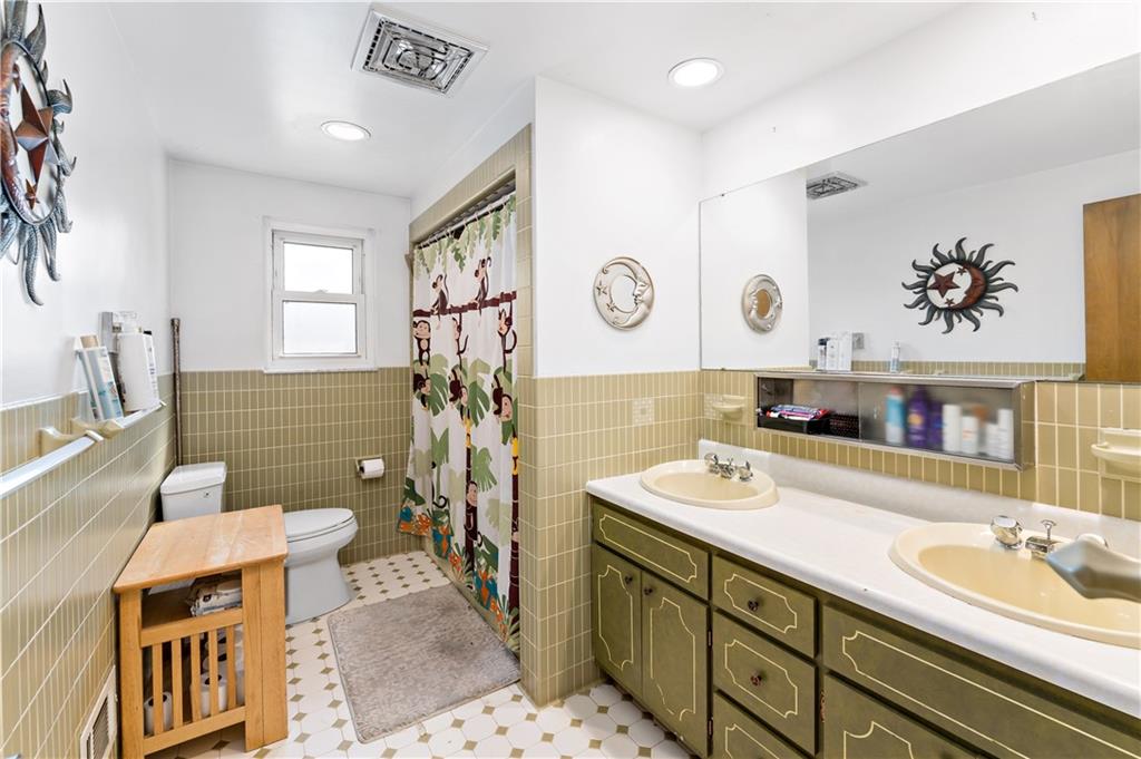 38 May Avenue McKees Rocks, PA 15136 - Photo 21 of 38 a bathroom with a sink a mirror and a toilet