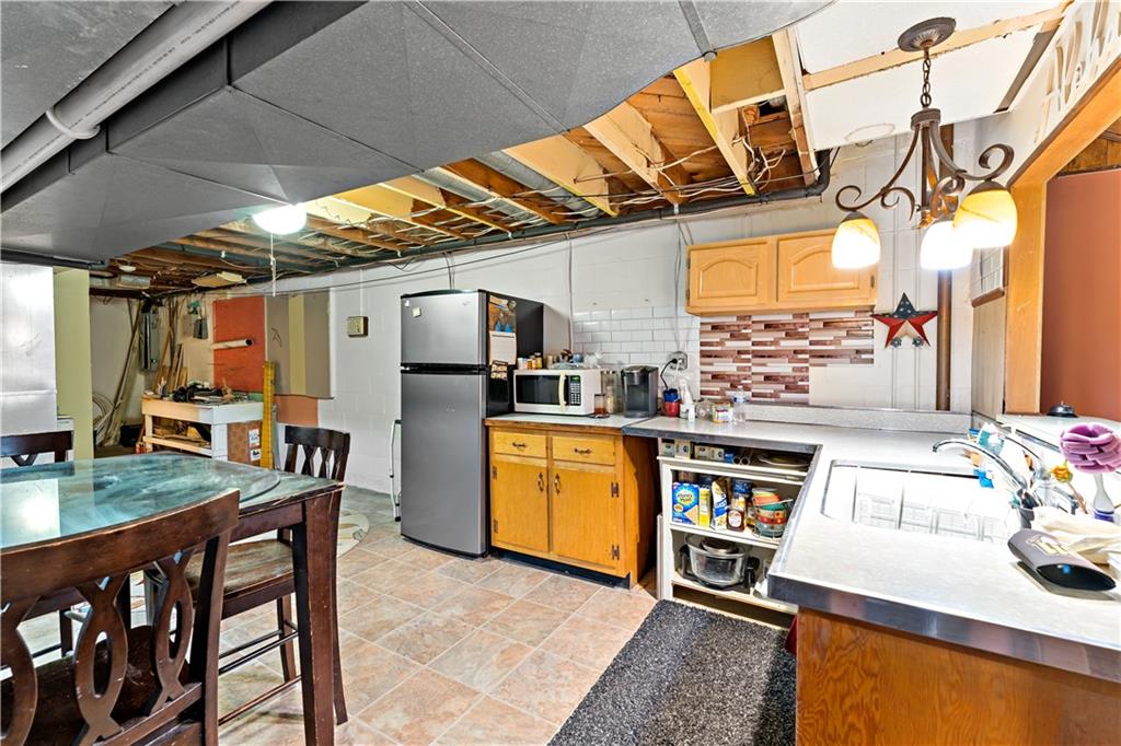 38 May Avenue McKees Rocks, PA 15136 - Photo 26 of 38 a kitchen with stainless steel appliances granite countertop a sink and wooden cabinets