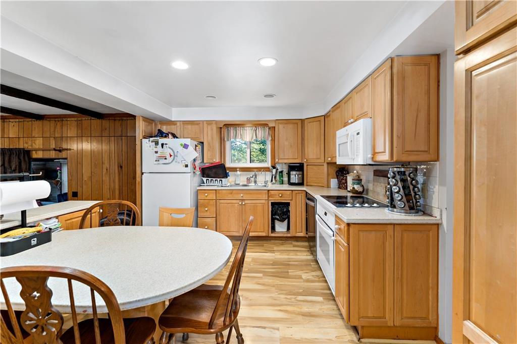 38 May Avenue McKees Rocks, PA 15136 - Photo 8 of 38 a kitchen with a table chairs refrigerator and cabinets