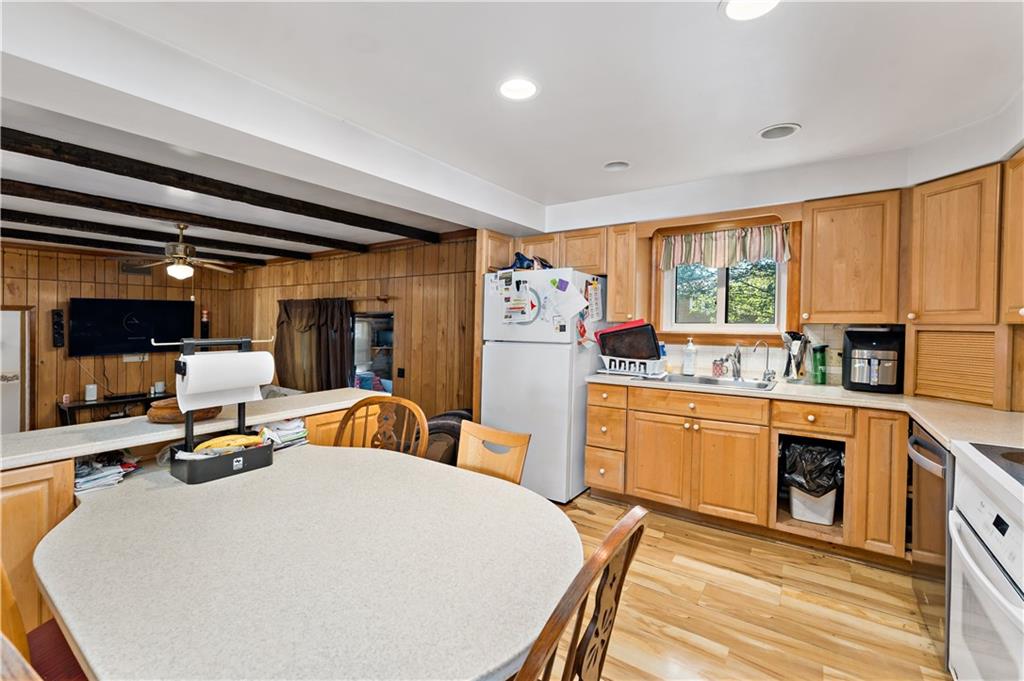 38 May Avenue McKees Rocks, PA 15136 - Photo 9 of 38 a kitchen with stainless steel appliances granite countertop a stove a sink dishwasher and a refrigerator with wooden floor