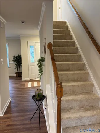 a view of staircase with wooden floor and stairs