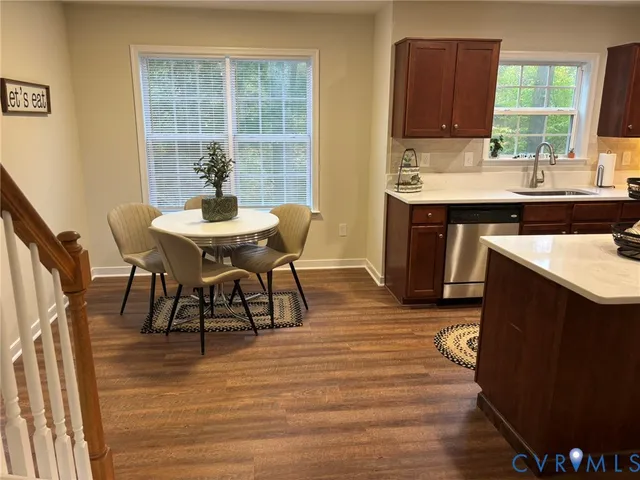 a view of a dining room with furniture and window