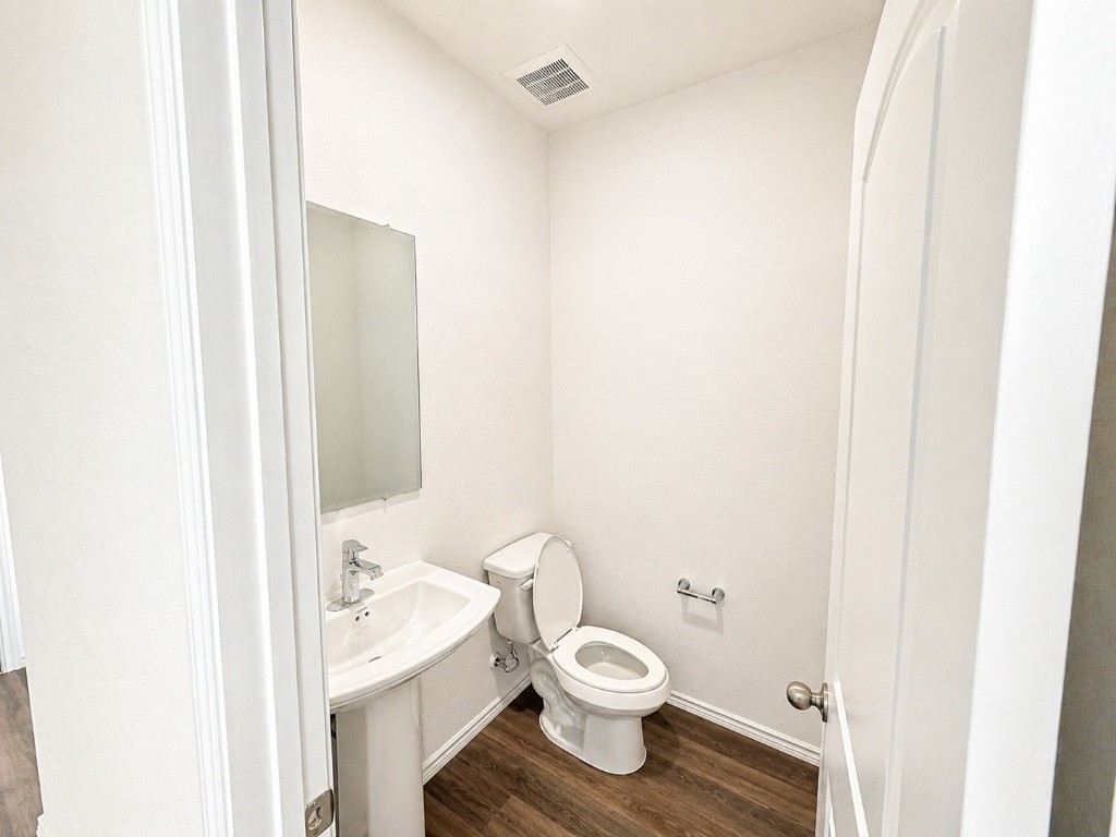 5218 Mossdale Blf Lane Spring, TX 77373 - Photo 5 of 14 a bathroom with a toilet a sink and a mirror