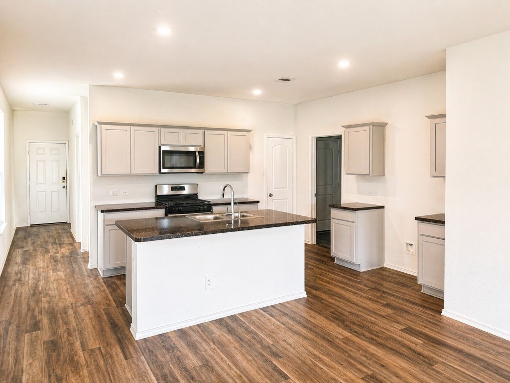 5218 Mossdale Blf Lane Spring, TX 77373 - Photo 7 of 14 a kitchen with a refrigerator and a stove top oven