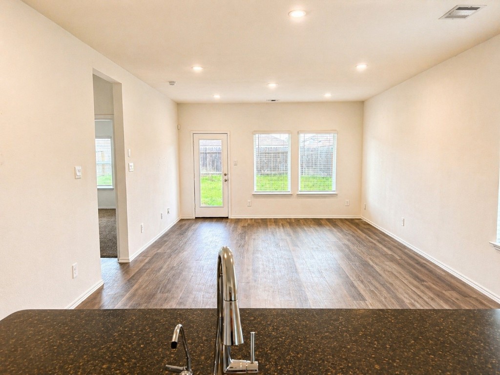 5218 Mossdale Blf Lane Spring, TX 77373 - Photo 8 of 14 wooden floor in an empty room with a window