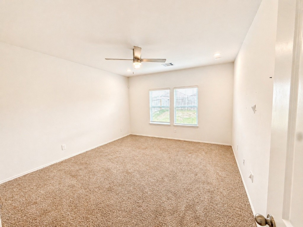 5218 Mossdale Blf Lane Spring, TX 77373 - Photo 9 of 14 an empty room with a window and a ceiling fan
