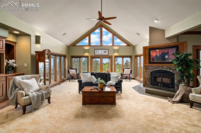 2755 Elk Ridge South Divide, CO 80814 - Photo 4 of 14 Living room with soaring vaulted ceilings, wood-burning fireplace, and an open concept with main-level access to the dining room, kitchen, primary suite, and walkout to the new rear composite deck with stunning views of the Front Range