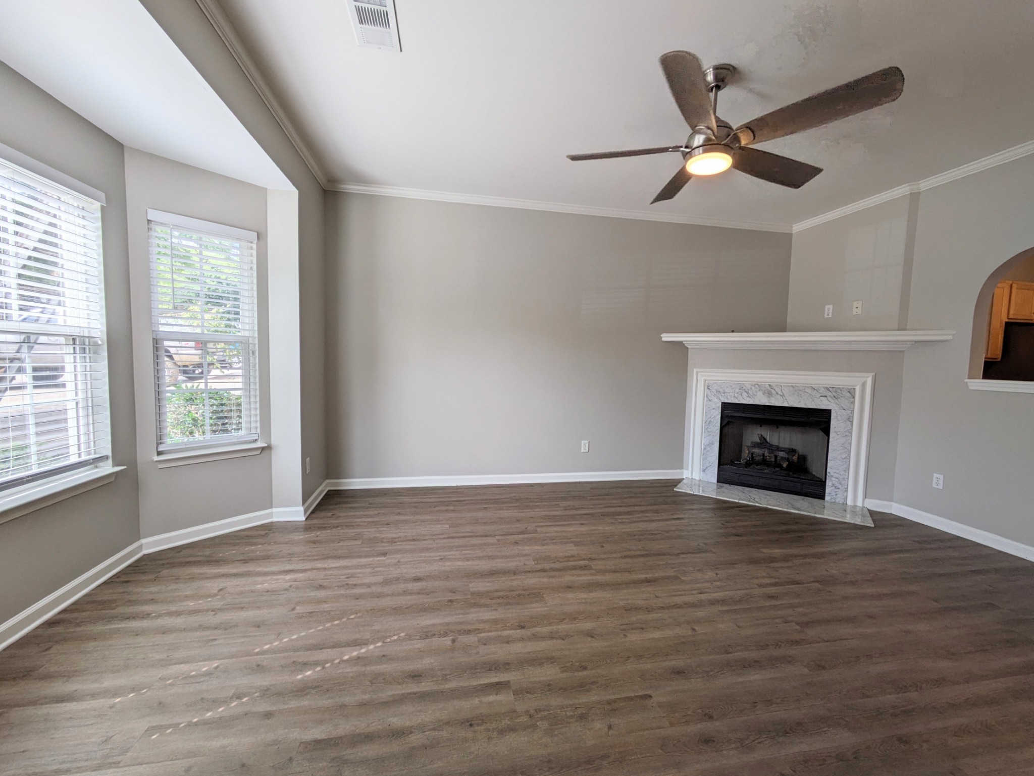 1101 Downs Boulevard, Unit B105 Franklin, TN 37064 - Photo 5 of 44 a view of an empty room with wooden floor fireplace and a window