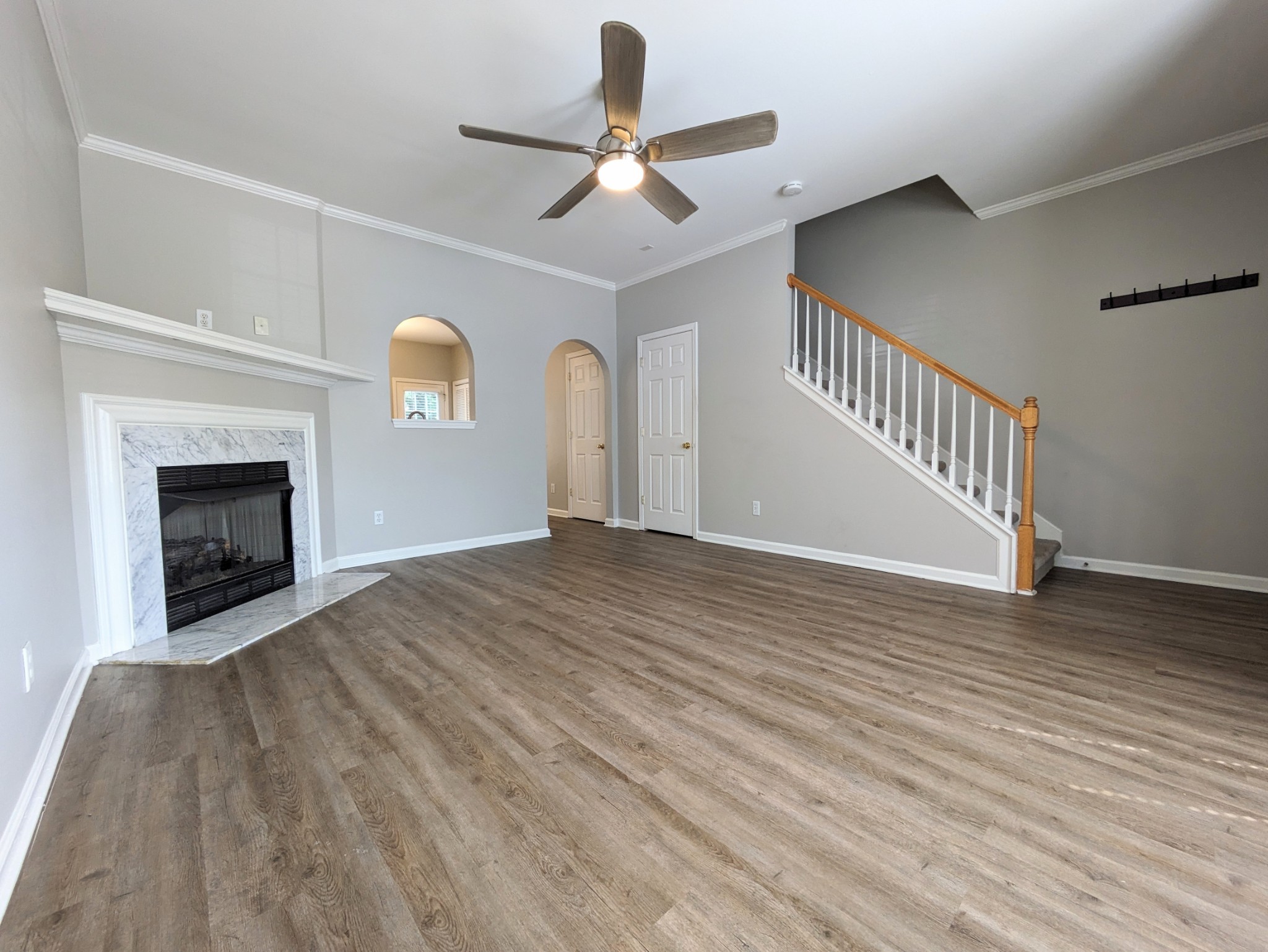 1101 Downs Boulevard, Unit B105 Franklin, TN 37064 - Photo 6 of 44 a view of an empty room with wooden floor fireplace and a window