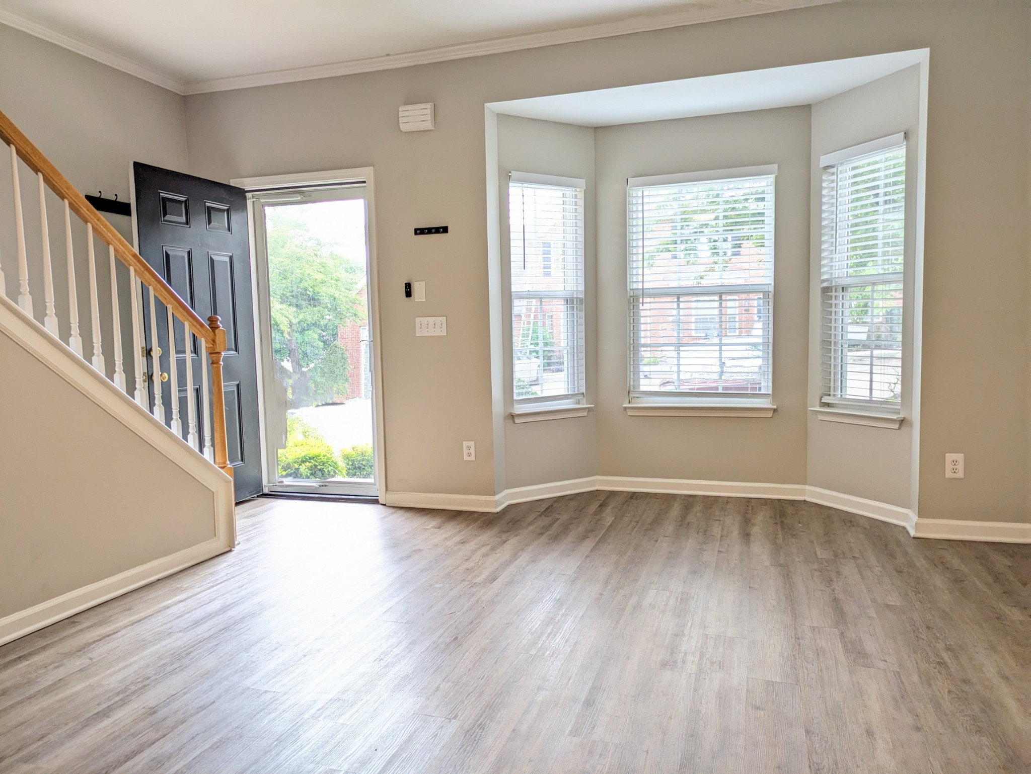 1101 Downs Boulevard, Unit B105 Franklin, TN 37064 - Photo 8 of 44 an empty room with wooden floor and windows