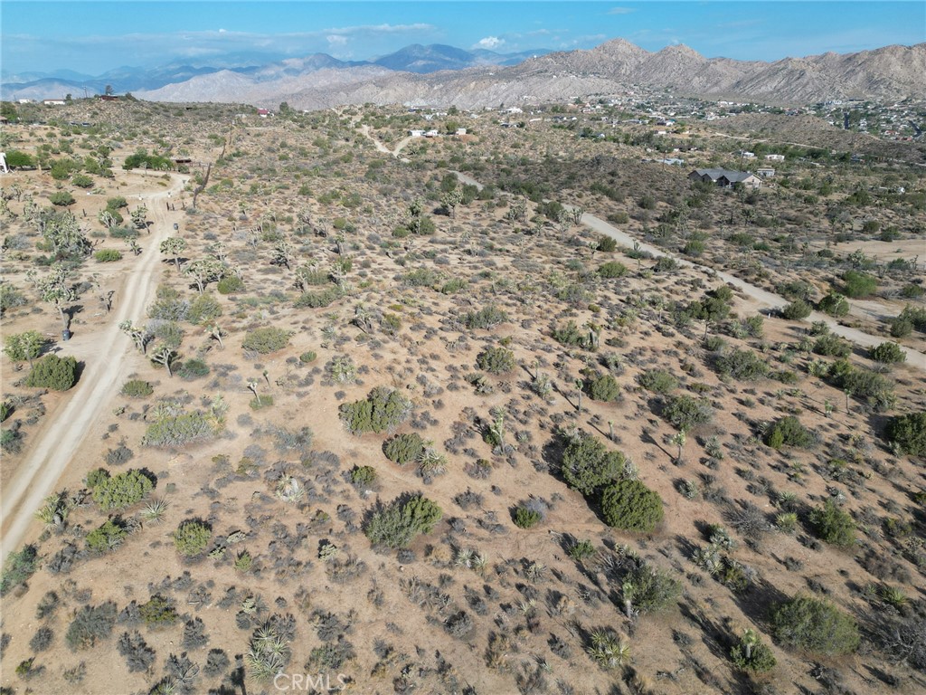 0 Kickapoo Trail Yucca Valley, CA 92284 - Photo 8 of 8 a view of a field with mountains in the background