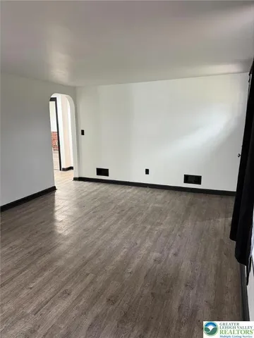 a view of an empty room and wooden floor