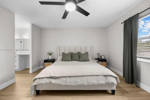 a bedroom with a bed and wooden floor