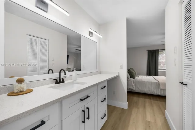 a en suite bathroom with double vanity sinks and a mirror