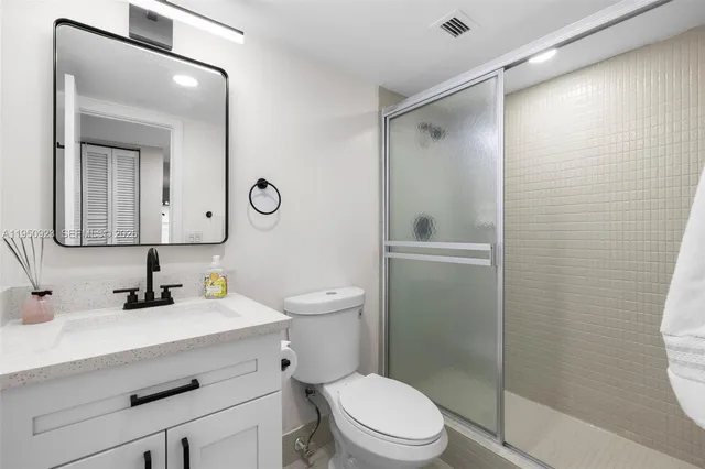 a bathroom with a toilet a sink and a mirror