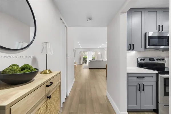 a kitchen with stainless steel appliances a stove refrigerator and microwave