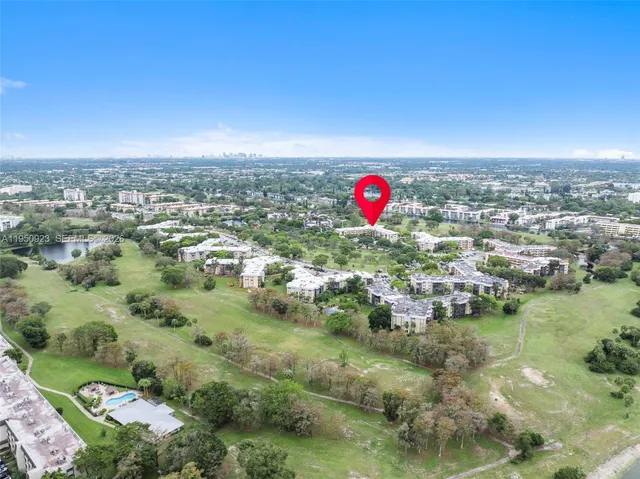 an aerial view of residential houses with outdoor space and swimming