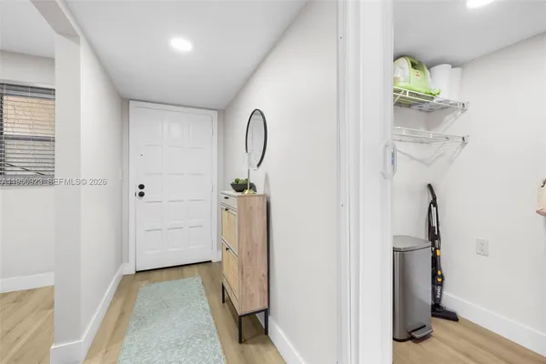 a view of an entryway with wooden floor