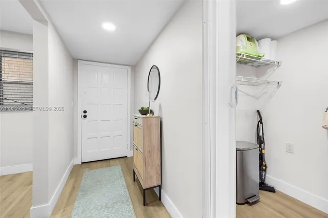 a view of an entryway with wooden floor