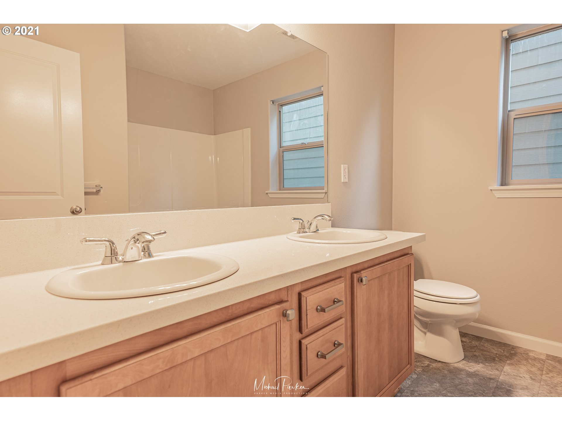 19947 Southwest Jette Lane Aloha, OR 97003 - Photo 21 of 26 a bathroom with a toilet a sink a mirror and a window