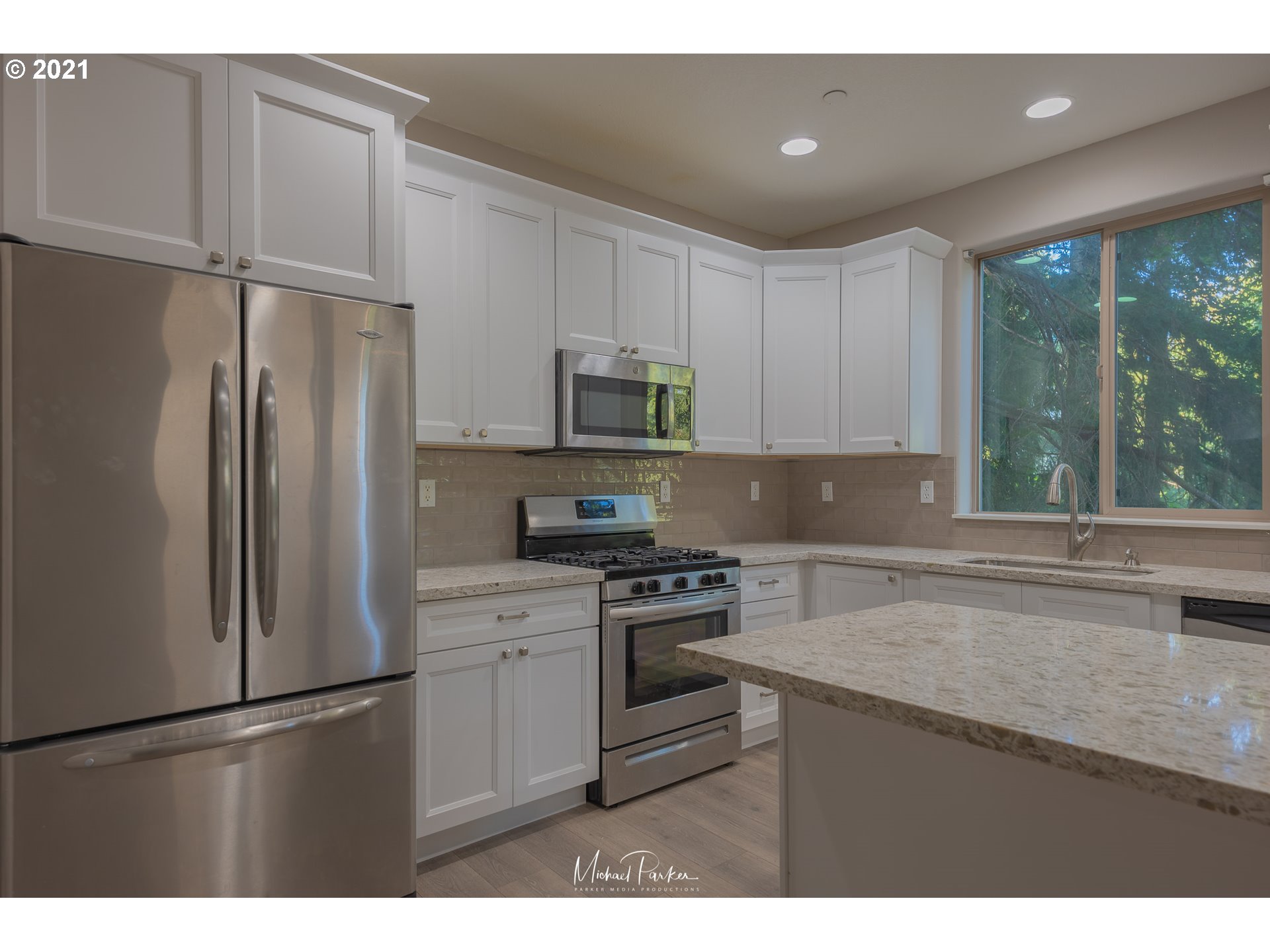 19947 Southwest Jette Lane Aloha, OR 97003 - Photo 8 of 26 a kitchen with stainless steel appliances granite countertop a refrigerator sink and cabinets