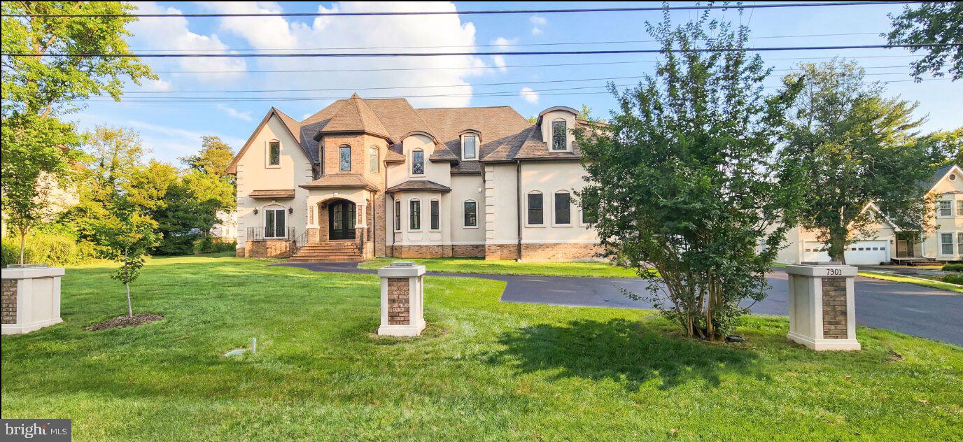 7301 Calvert Street Annandale, VA 22003 - Photo 6 of 18 a view of a white house with a yard and plants