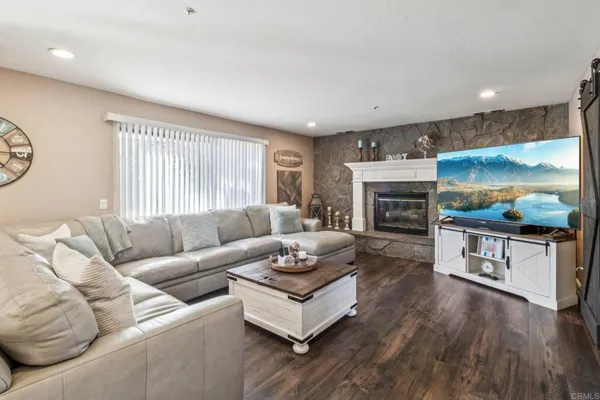 a living room with fireplace furniture and a flat screen tv