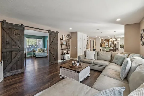 a living room with furniture and wooden floor