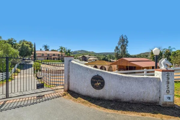 a view of a house with a backyard and a tree