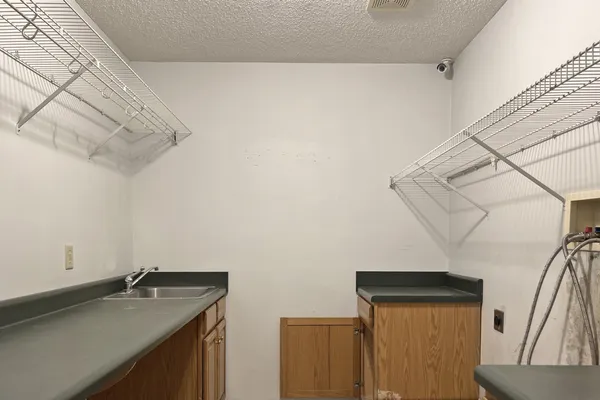 a bathroom with a granite countertop sink a mirror and vanity