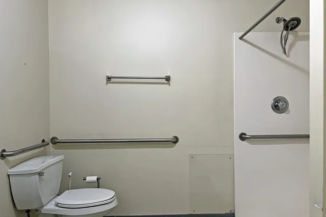 a bathroom with a toilet sink and shower