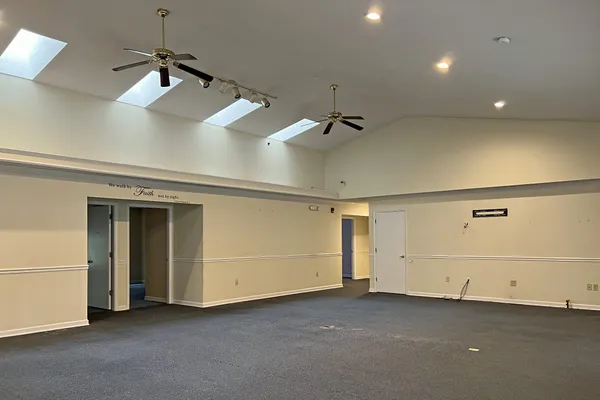 a view of a livingroom with a projector and a ceiling fan