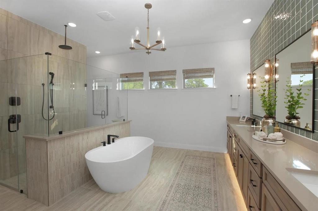 225 Bee Balm Road McKinney, TX 75071 - Photo 20 of 30 a spacious bathroom with a double vanity sink a mirror and a bathtub