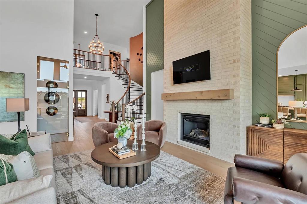 225 Bee Balm Road McKinney, TX 75071 - Photo 21 of 30 a living room with furniture a fireplace and a flat screen tv