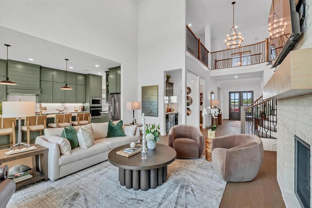 225 Bee Balm Road McKinney, TX 75071 - Photo 7 of 30 a living room with furniture and a chandelier