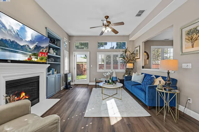 a living room with furniture and a fireplace