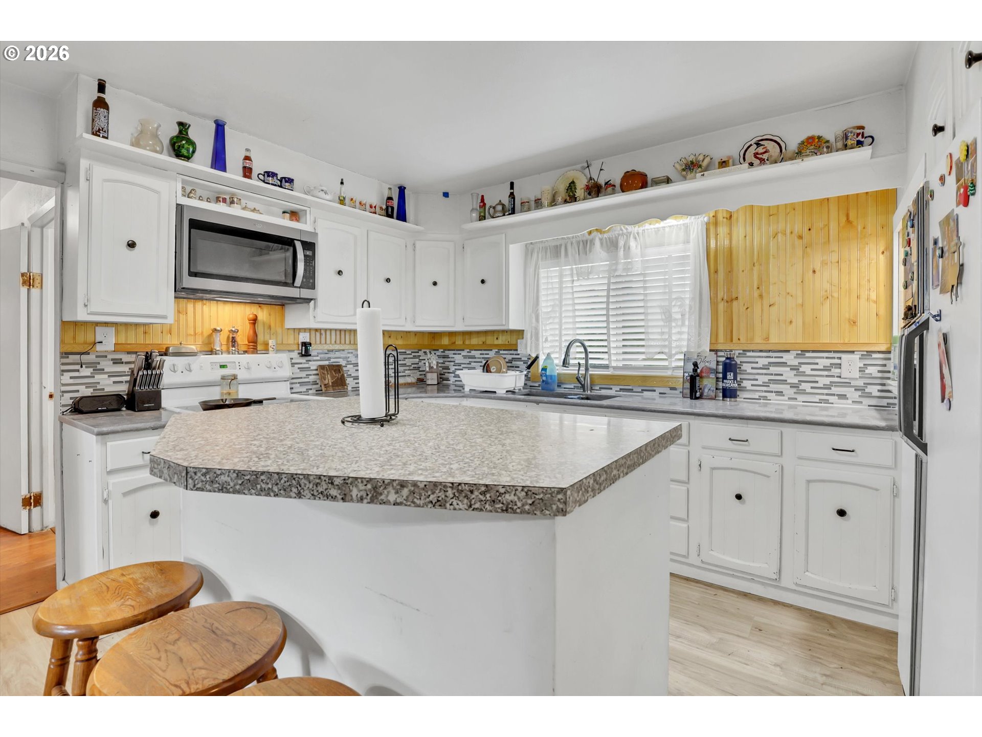 68763 Wasser Road Rainier, OR 97048 - Photo 18 of 34 a kitchen with granite countertop a sink a stove and cabinets