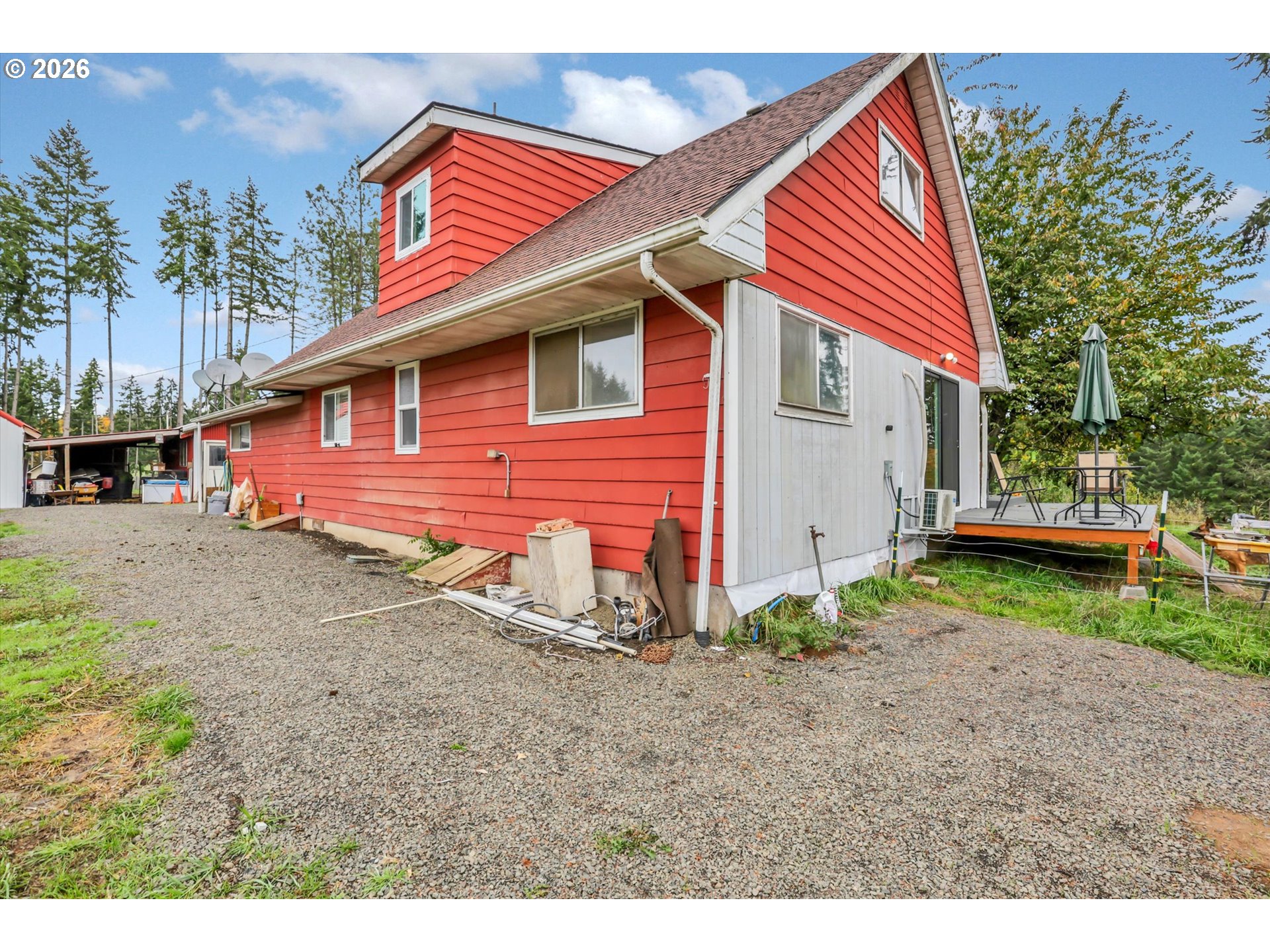 68763 Wasser Road Rainier, OR 97048 - Photo 2 of 34 a backyard of a house with plants and outdoor seating