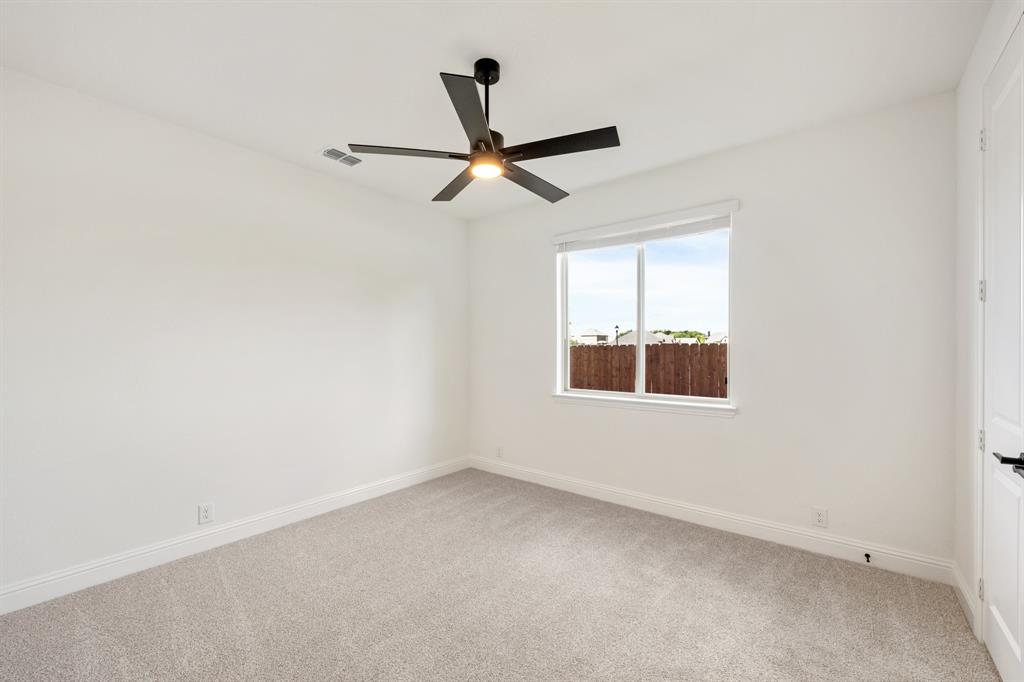 3433 Nightingale Lane Midlothian, TX 76065 - Photo 23 of 40 an empty room with a window and a ceiling fan