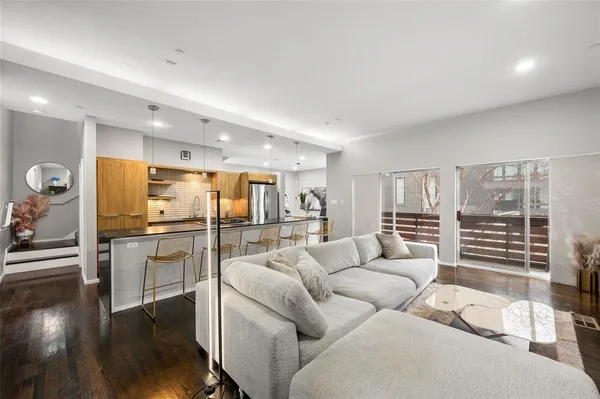 a living room with furniture and a kitchen view