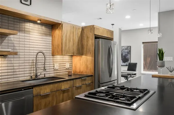 a kitchen with stainless steel appliances a stove and a refrigerator