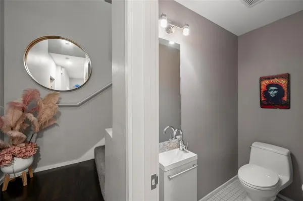 a bathroom with a toilet a sink and mirror