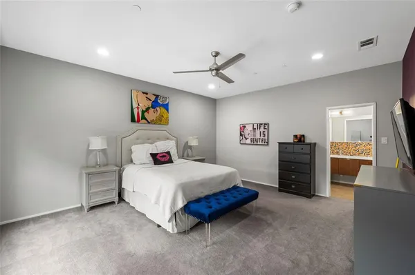 a bedroom with a bed and a television