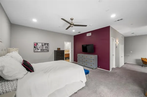 a bedroom with a bed and a television